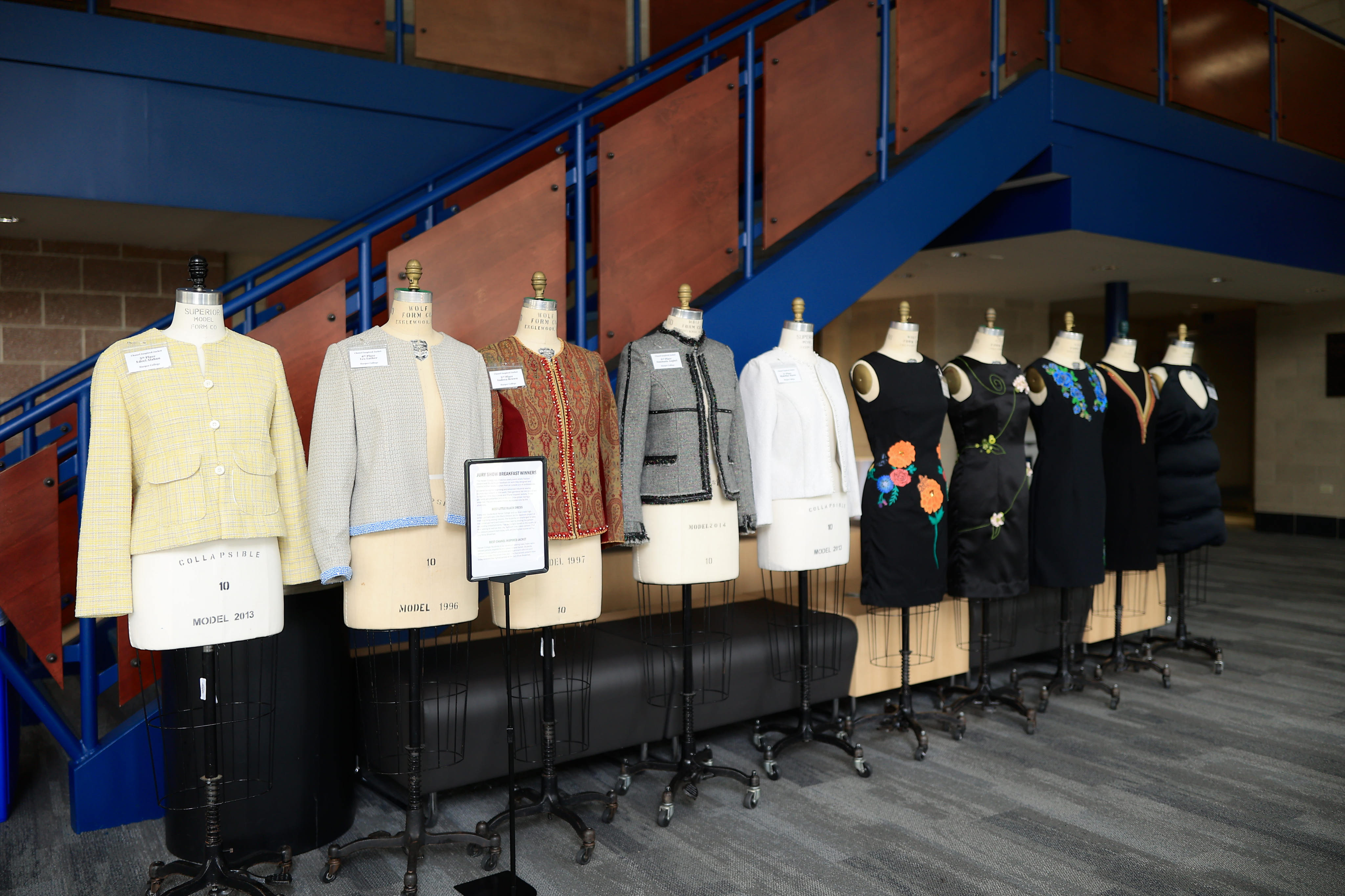 A line of mannequins dress in different outfits created by students