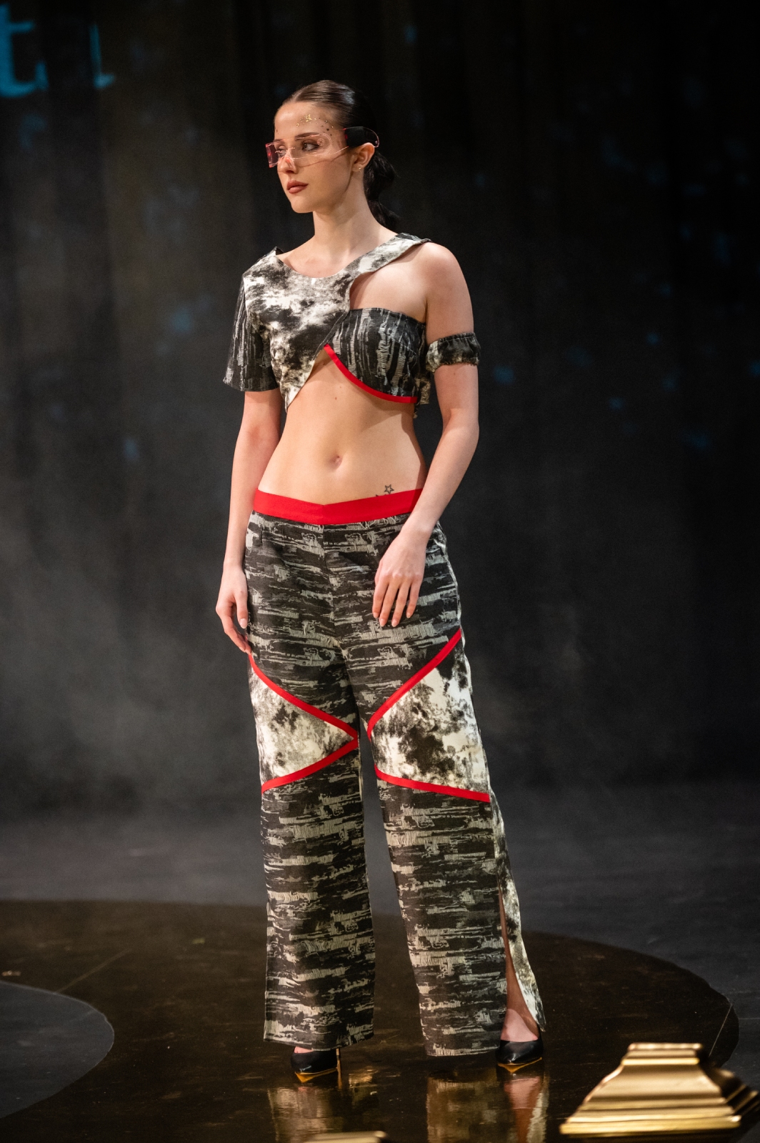 A model poses in a chic two-piece camouflage outfit