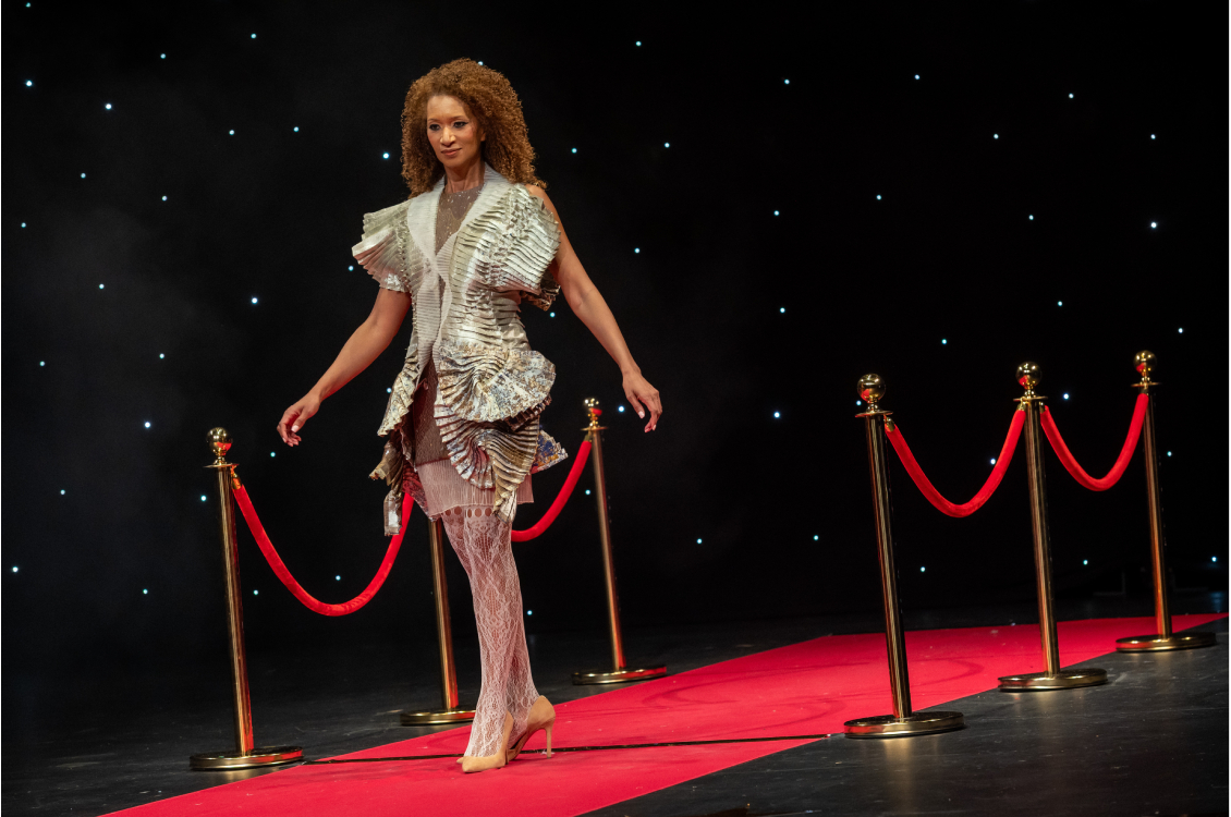 Model walking on the red carper runway