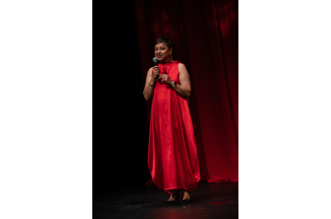 woman speaking in the microphone on the runway show