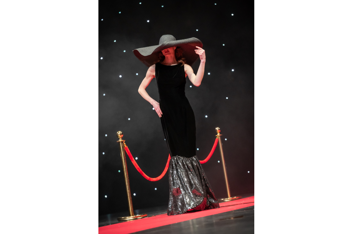 model with a large sunhat posing on runway