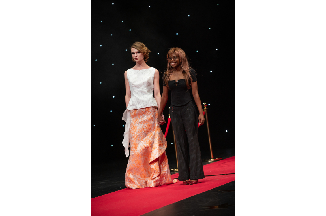 two models crossing eachother on runway