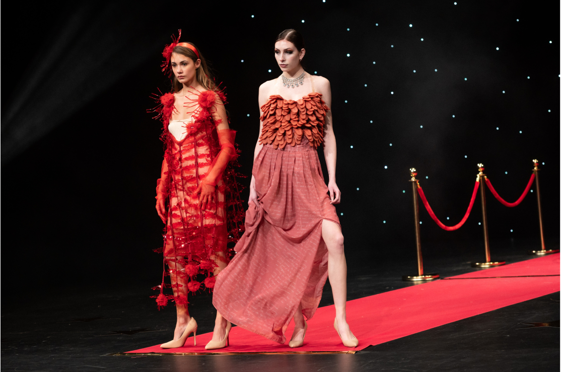two models posing on runway