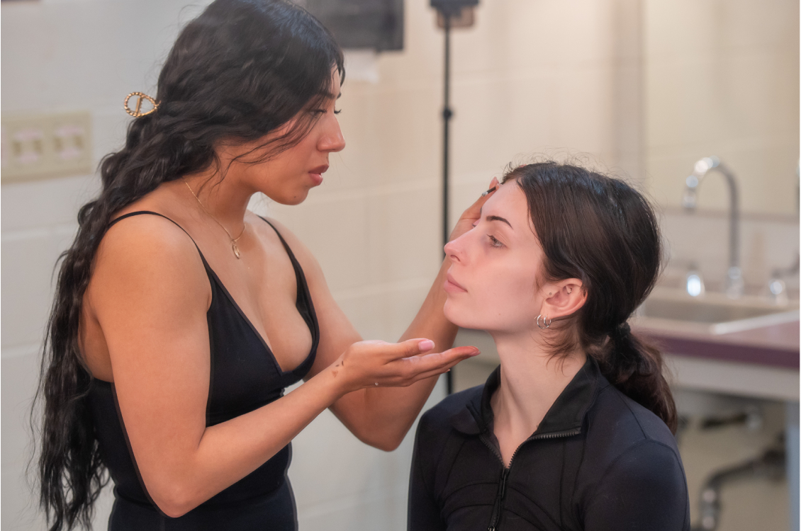 Backstage makeup artist doing makeup on a model