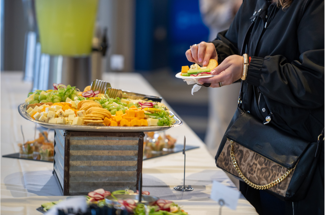 charcuterie board person grabbing a plate