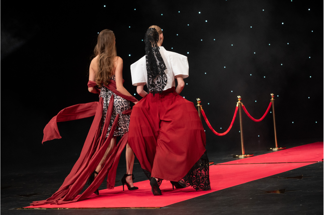 two models walking back on runway