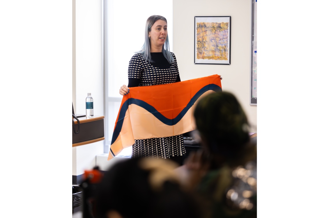 Dr. Lelaine Rigatto holding up a red and white scarf