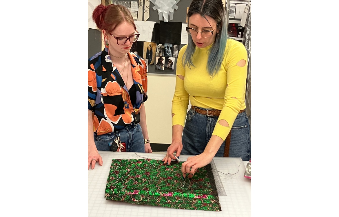 Dr. Lelaine Rigatto showing a student how to work with fabric