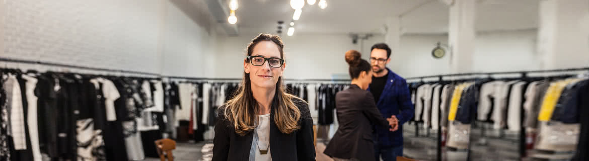 Woman working on clothing boutique.