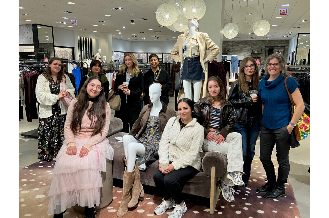 Harper fashion studies students pose “inside” a floor display at Neiman Marcus.