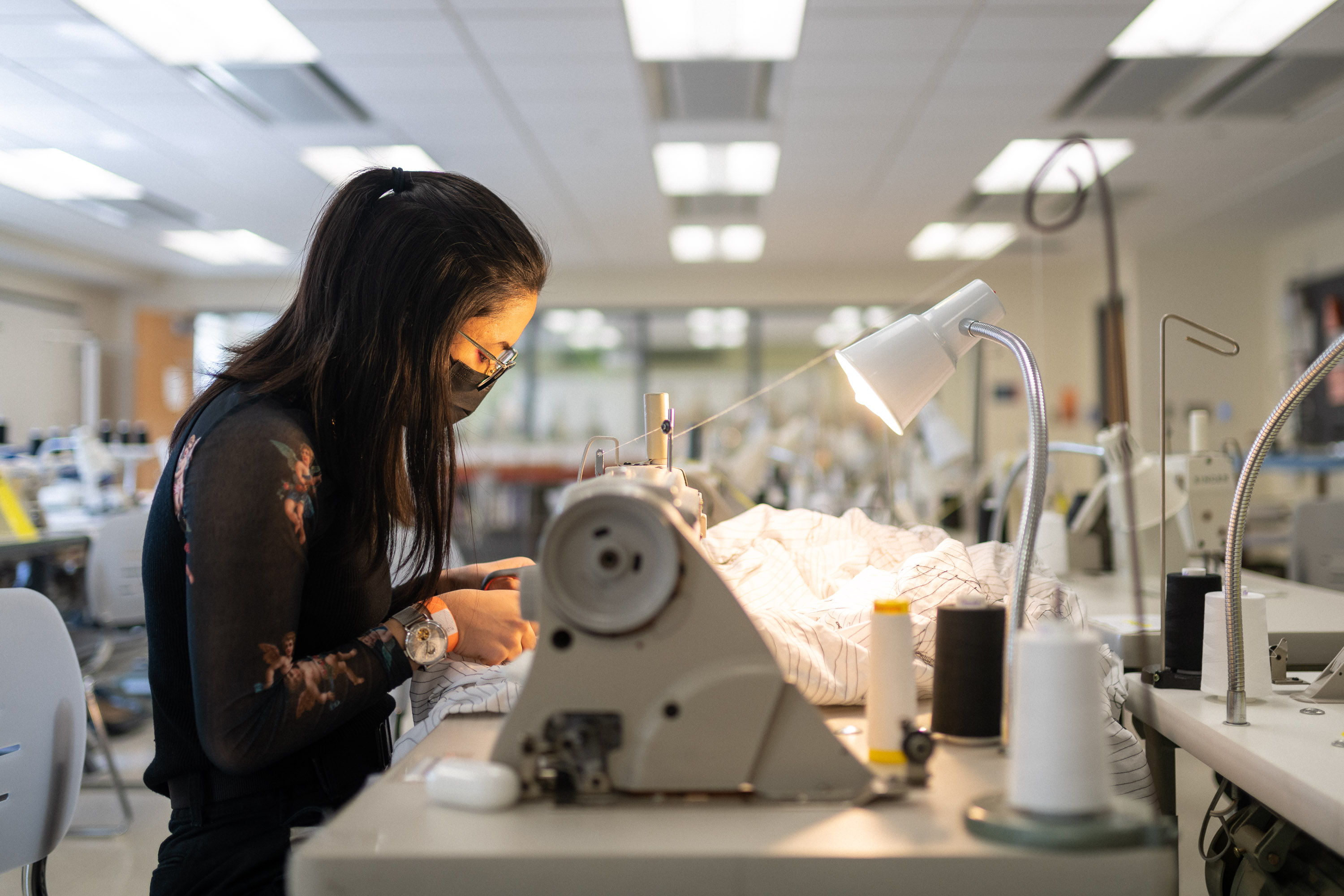 female student working at sewing machine