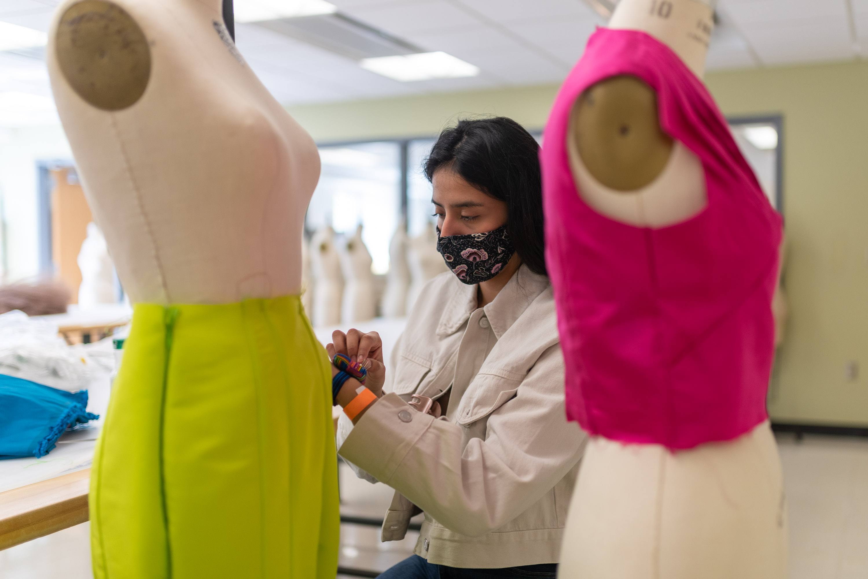 student working with dress mannequins