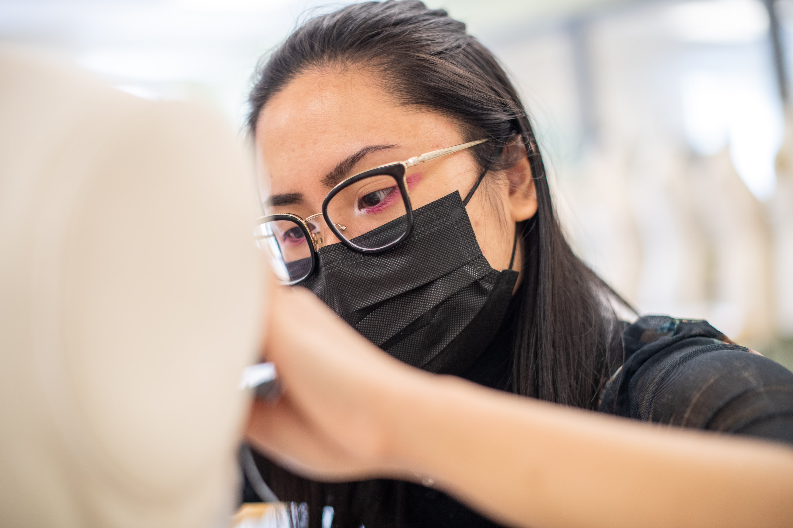 close up of student working on clothing