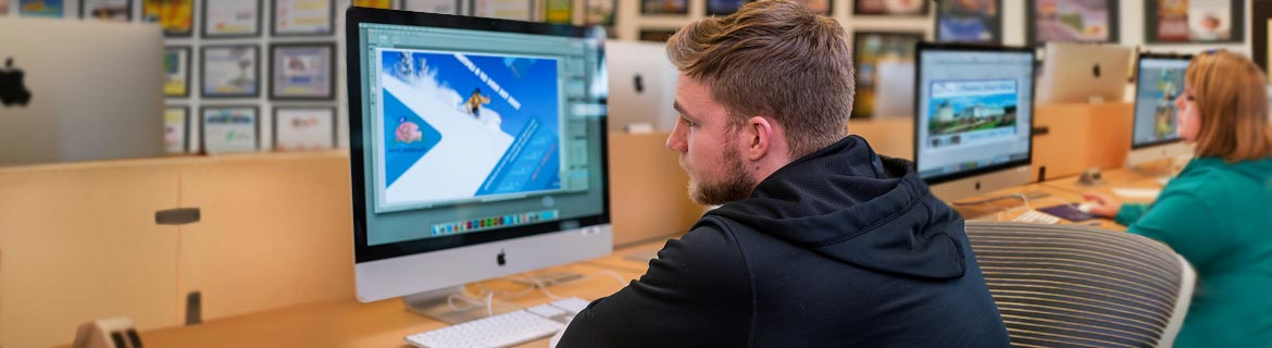 Student works on developing graphic image on computer 