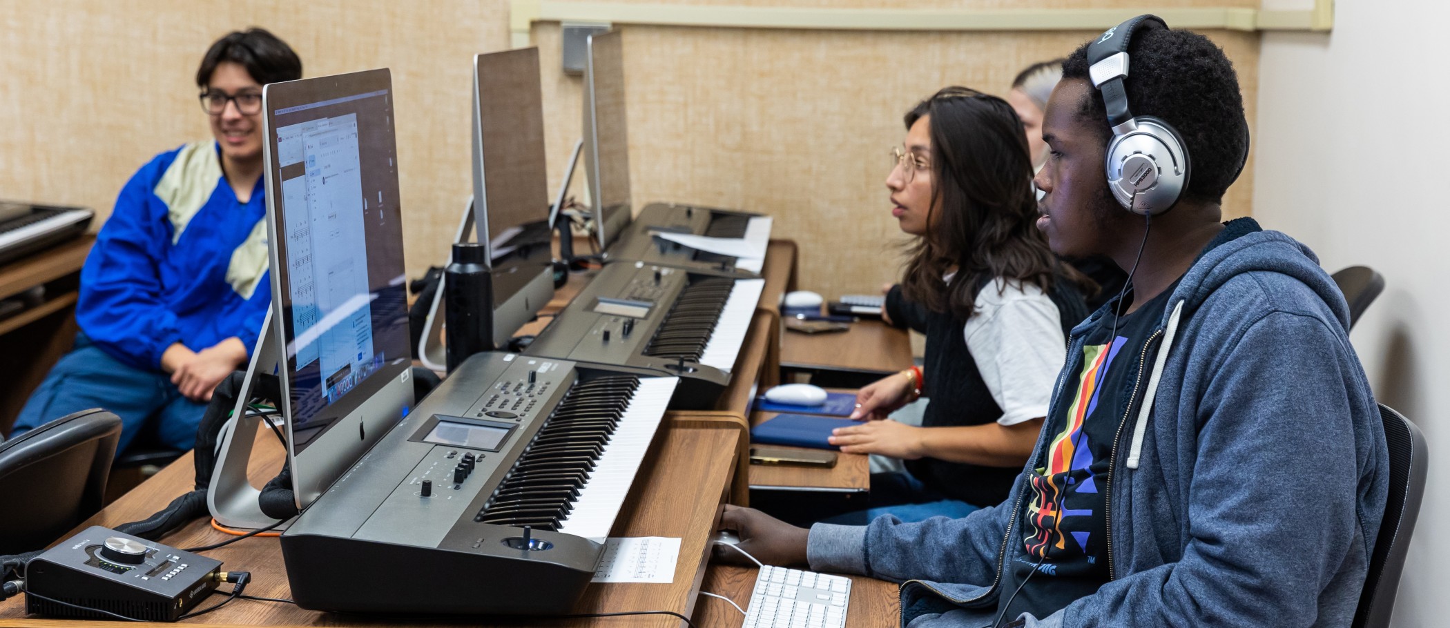 Harper College music students attending group piano class.