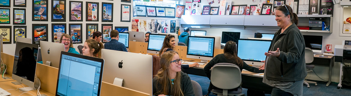 Students examining code on a computer screen