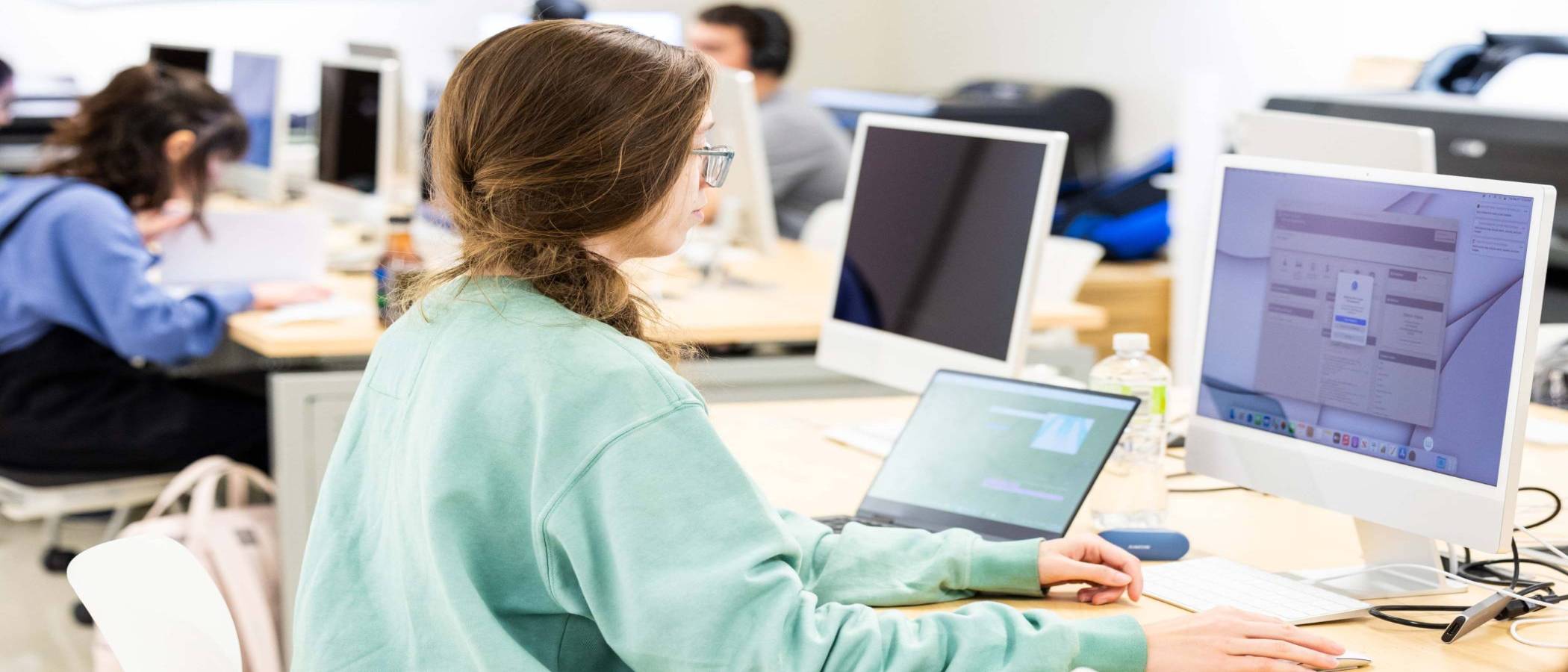 Students in the web design program working in a computer lab on a web development project.