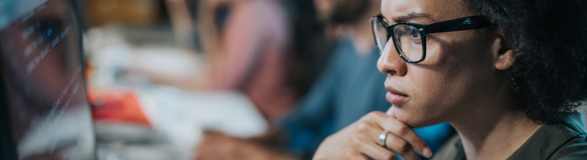 Machine learning engineer editing Python code on her computer.