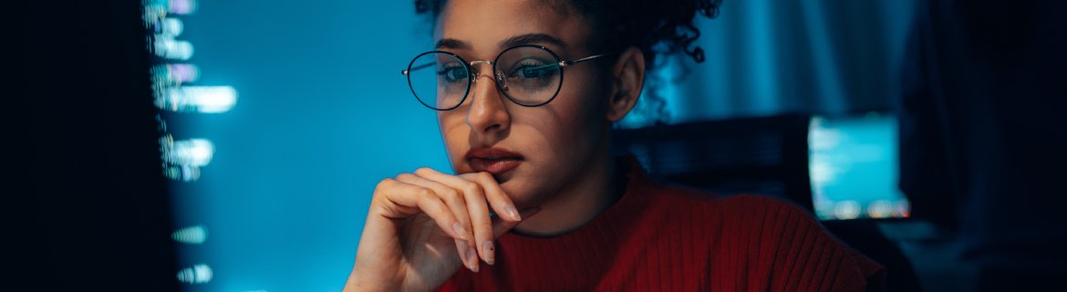 An AI strategist focused and working on a computer.