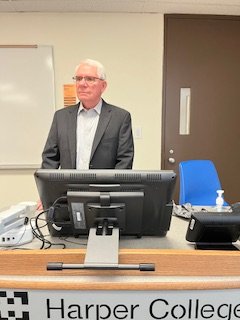 Photo of Gerald Kmiecik stading at a lecture podium