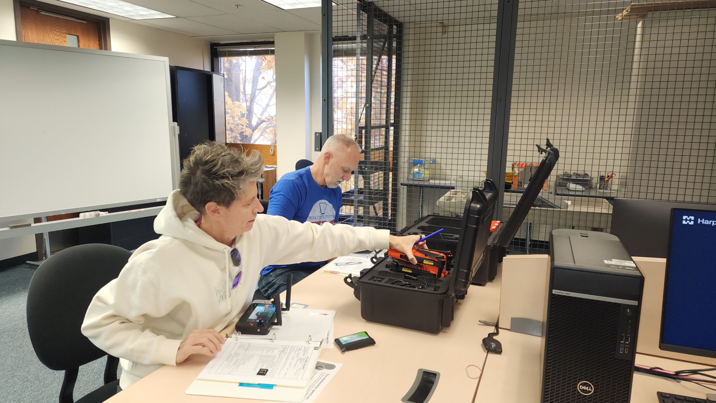 Two GIS/Drone Technology students unpacking a drone in a classroom