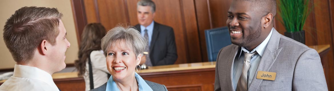 Hotel manager conversing with hotel guests