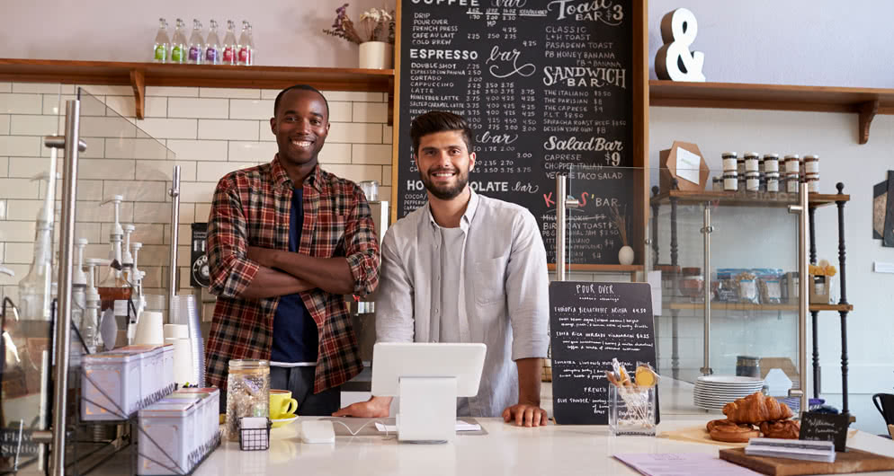 Two business partners standing in their cafe photo.