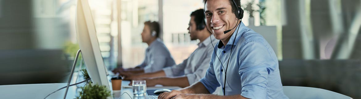 Man wearing a headset in front of computer