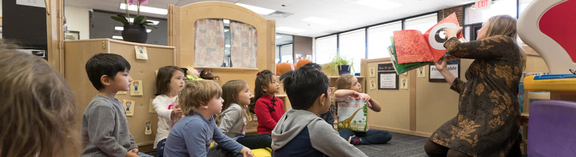 Teacher reading book to students