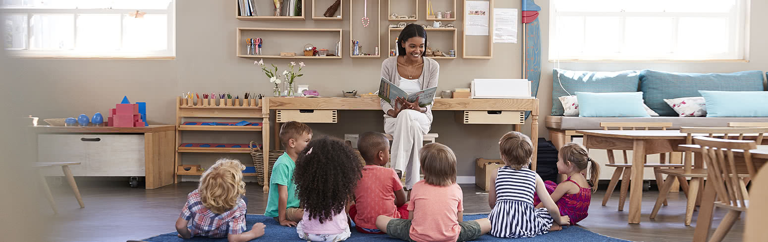 Teacher reading book to students