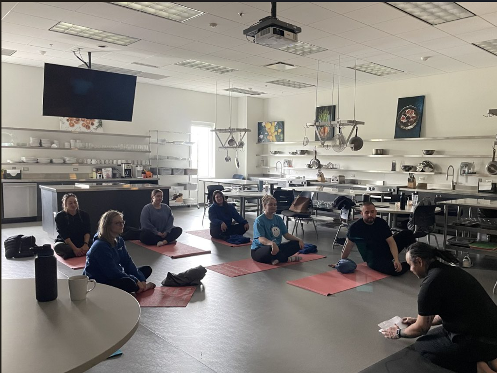 Students do yoga in Nutrition Lab classroom area
