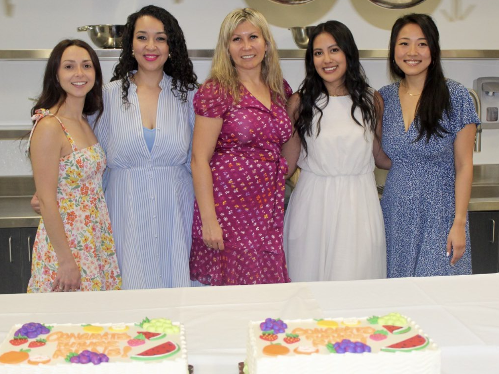 Students pose in Nutrition Lab with festive cakes