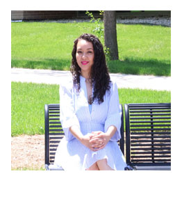 Isabel sits on a bench