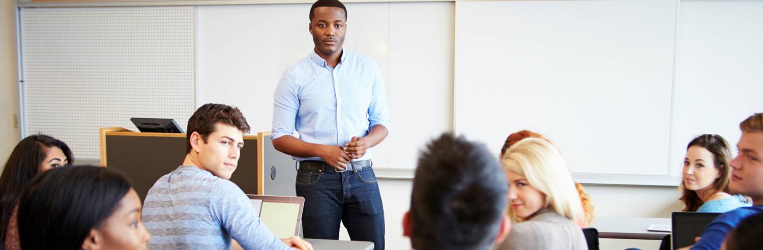 High school teacher in front of classroom