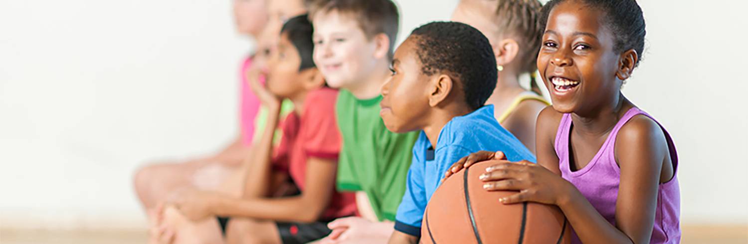 Students holding a basketball in class for pe endorsement online