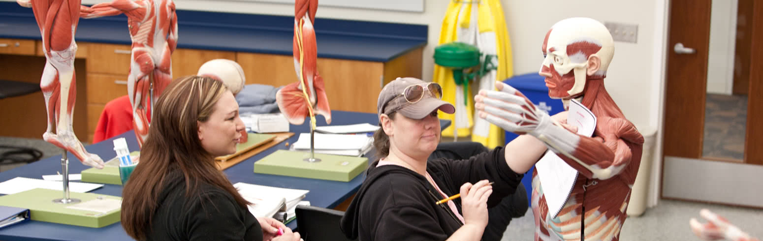 Health career student stands with patient photo