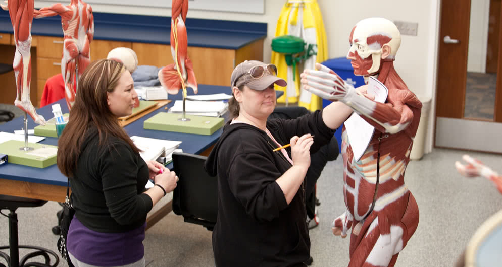 Health career student stands with patient photo