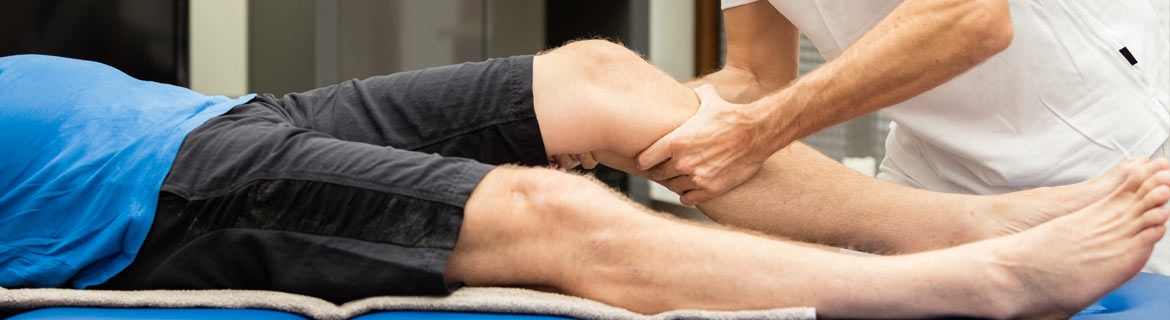Person performing massage therapy on another person's leg