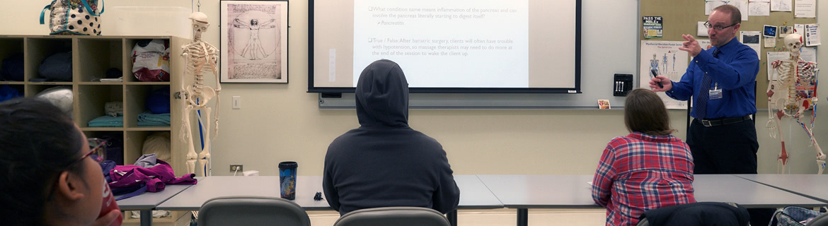 Instructor teaching a lesson to massage therapy program students at the Harper College campus in Palatine, IL.