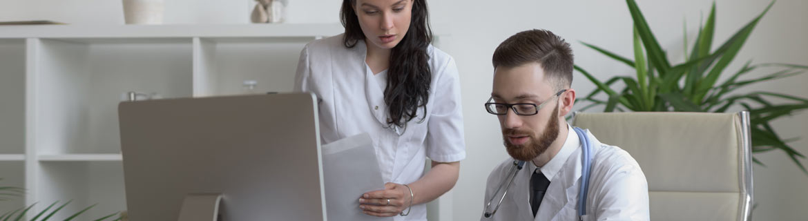 Medical assistant and physician at a computer 