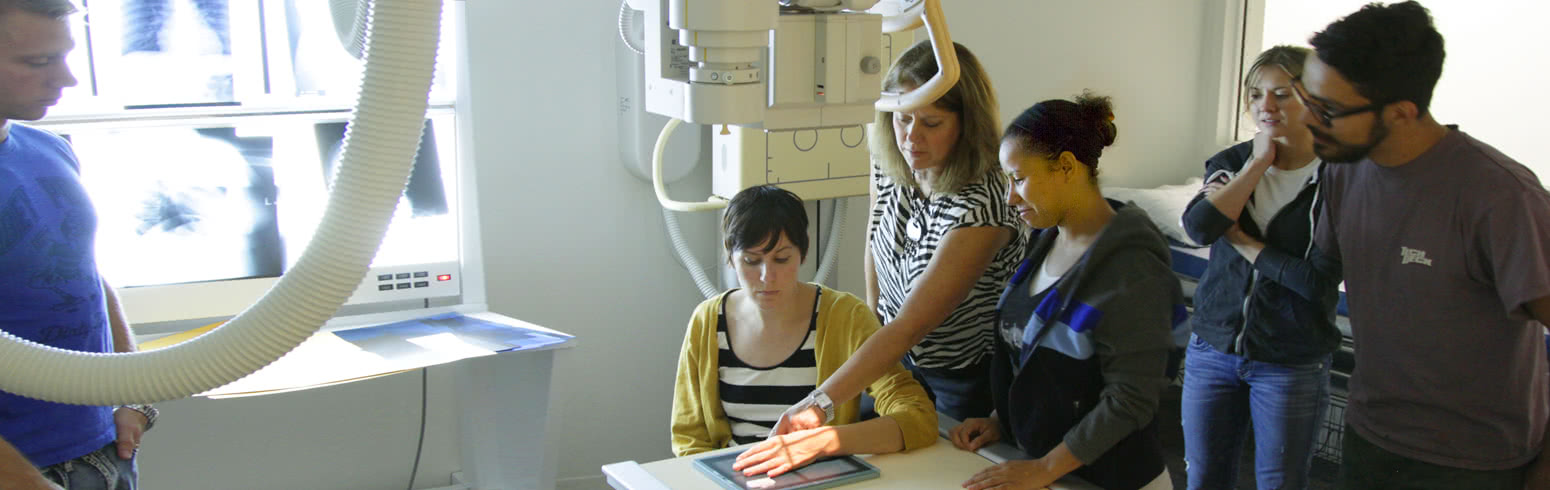 Students learning how to perform an X-Ray on a patient's hand at the medical classroom facility on the Harper College campus in the Chicago suburbs.