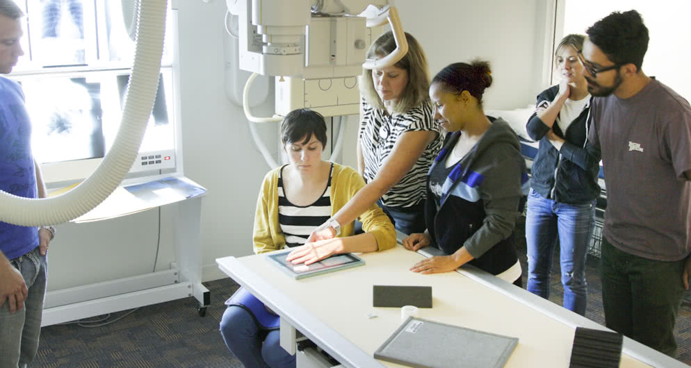Students learning how to perform an X-Ray on a patient's hand at the medical classroom facility on the Harper College campus in the Chicago suburbs.