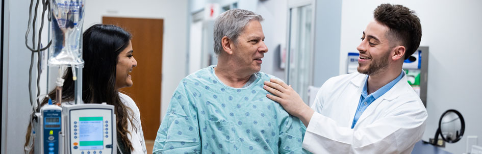 two student working with a patient in simulation hospital