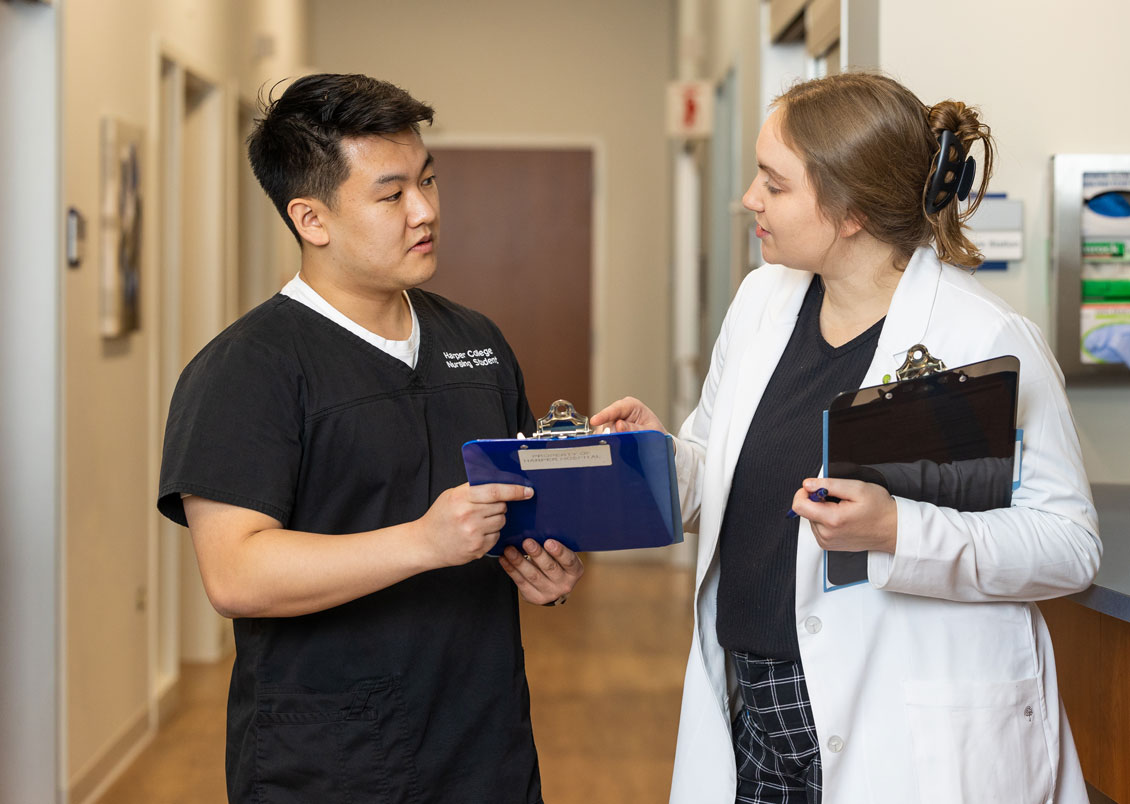 two students discuss a patient chart