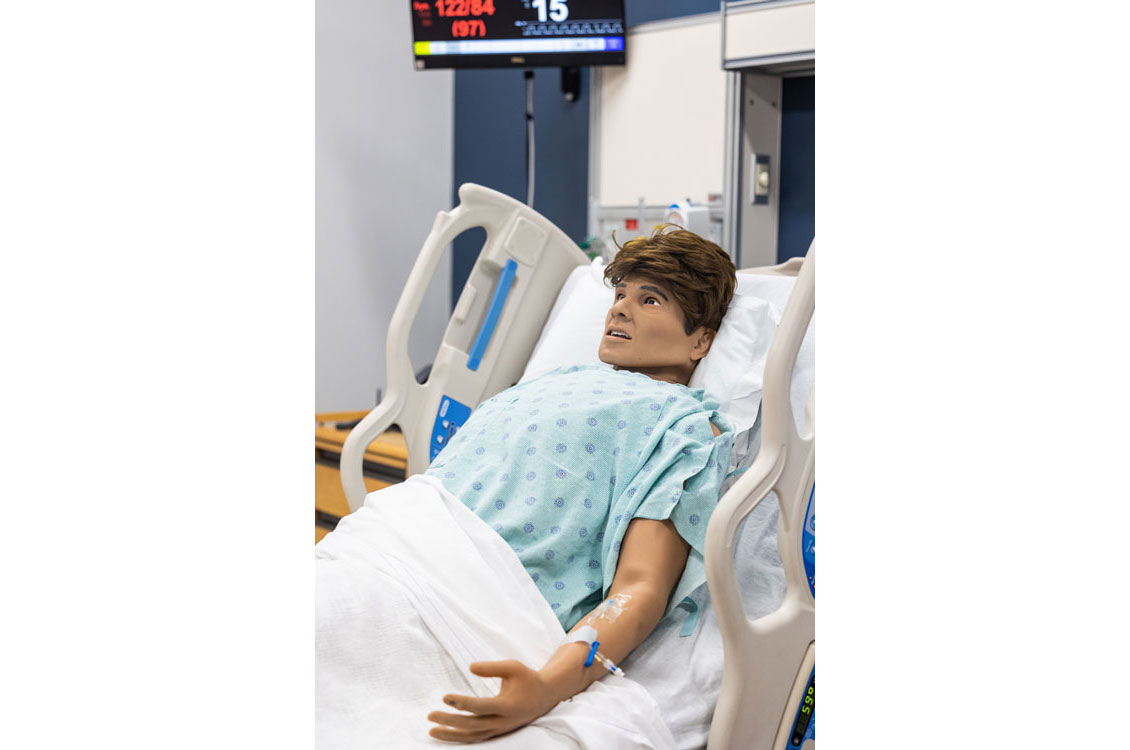 a simulation dummy sitting in a hospital bed