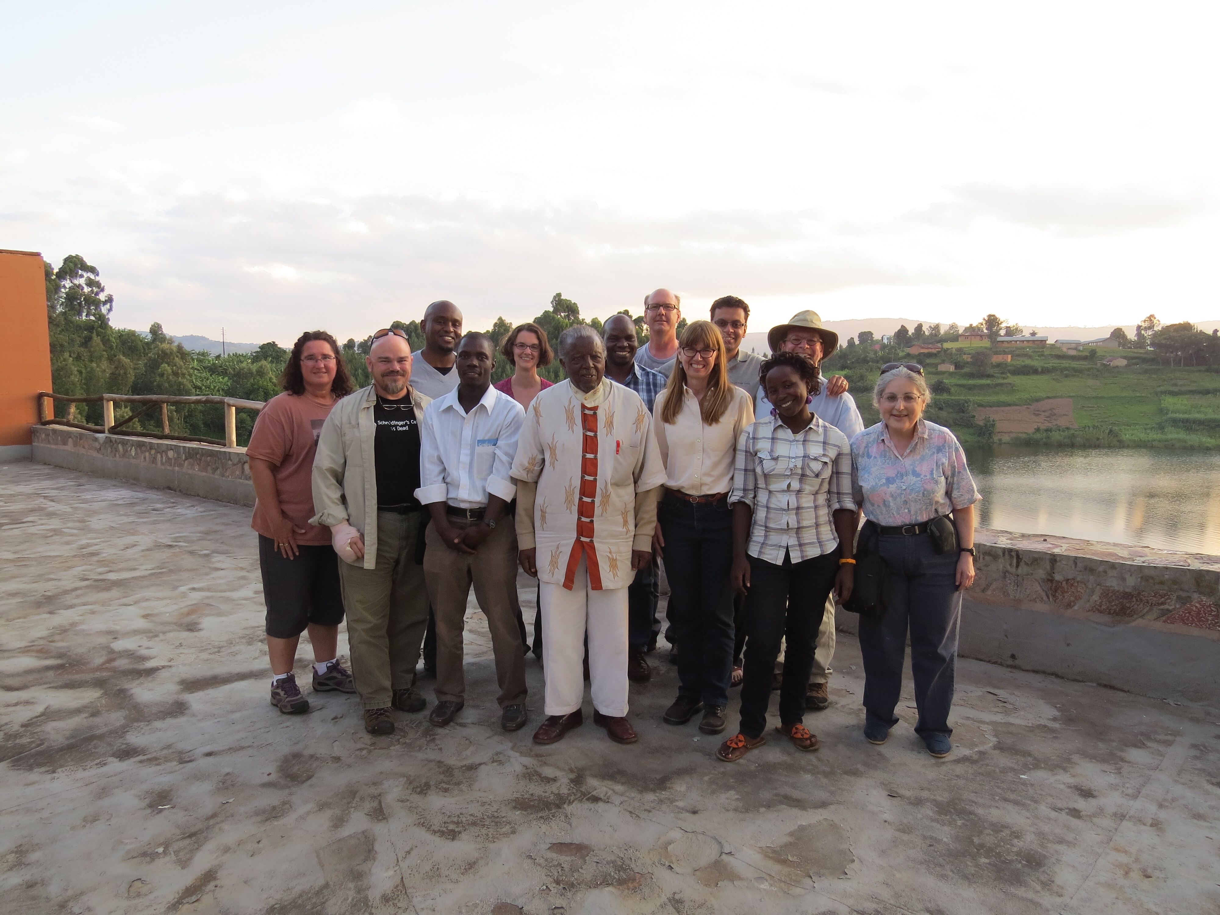 Harper faculty with Muguruzi next to a lake
