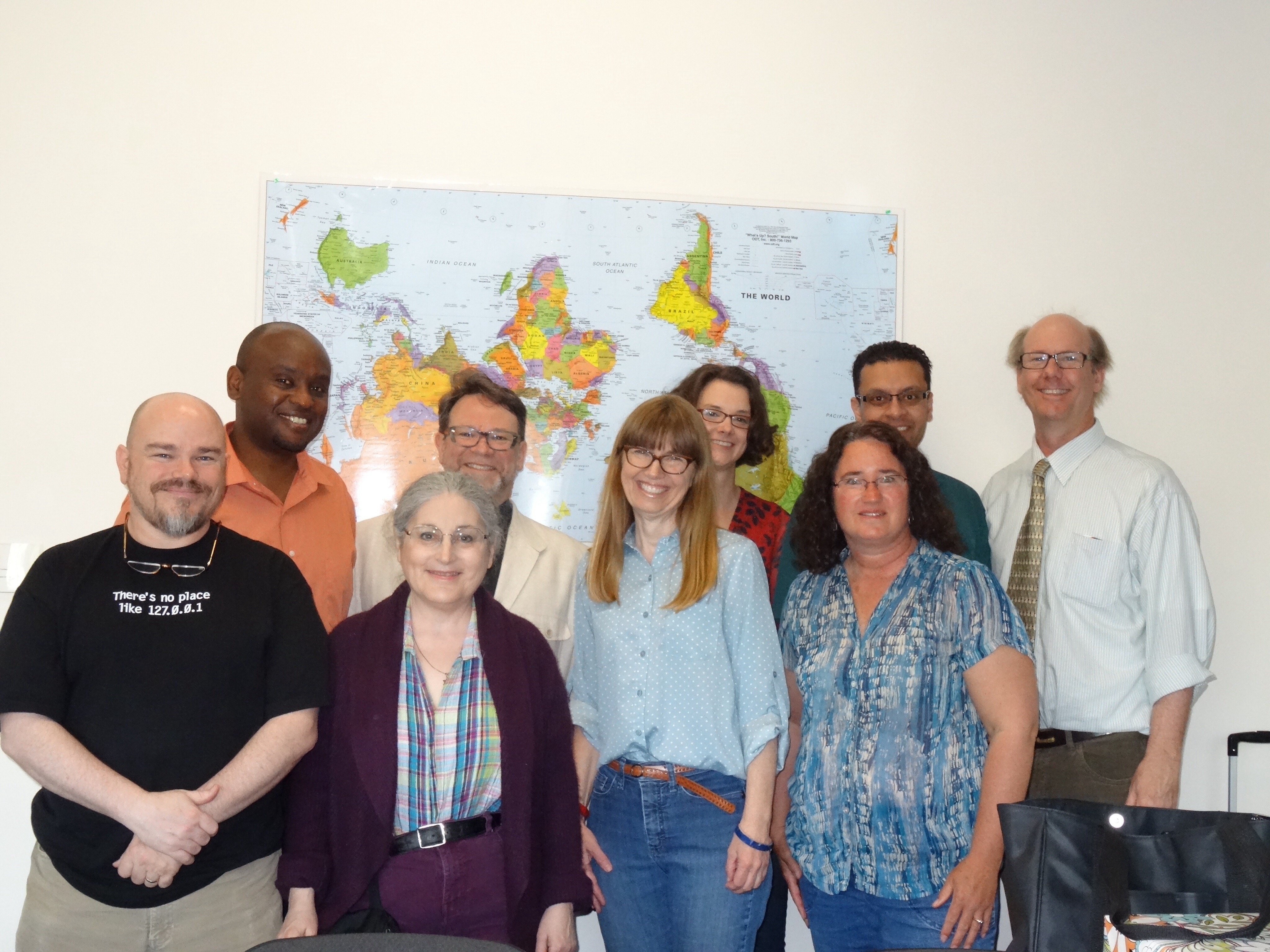 A group of professors smile for the camera