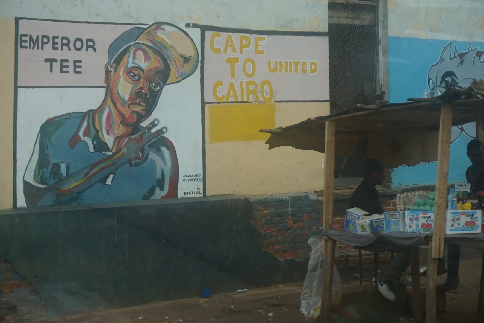 Mural of a man holding up the peace sign 