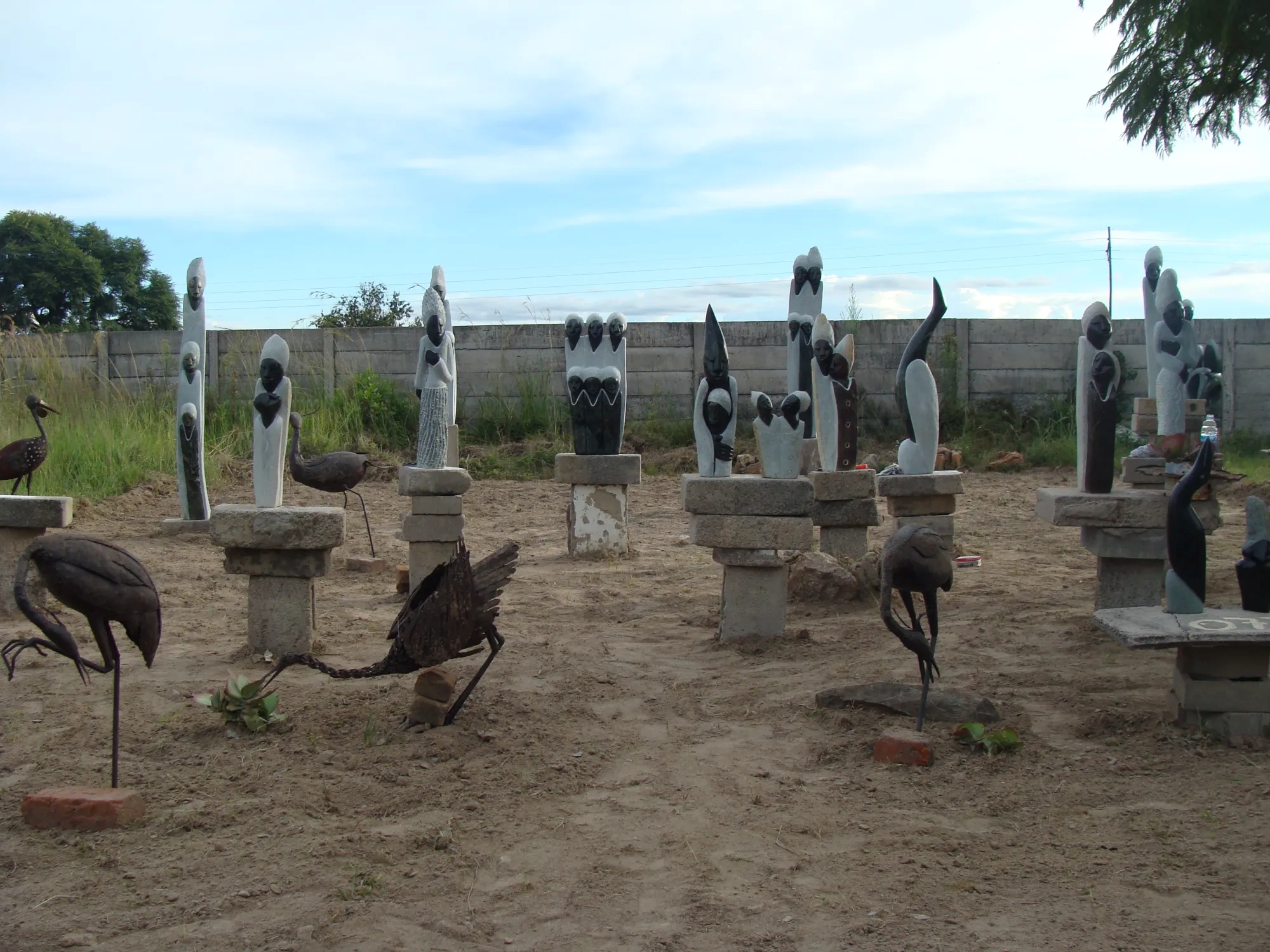 Scultpures depicting birds and African stles outside 