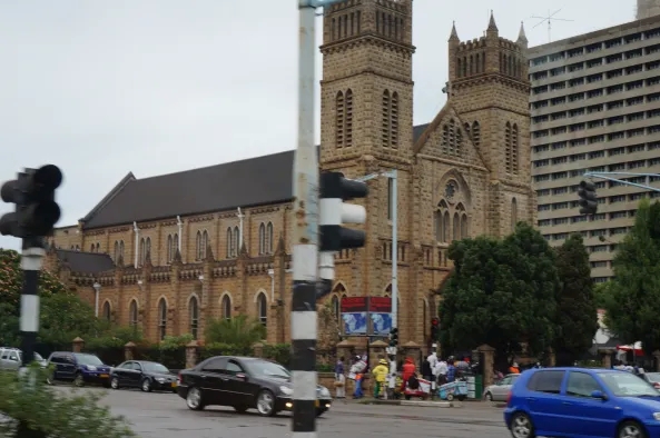 Brown stone cathedral on a busy street